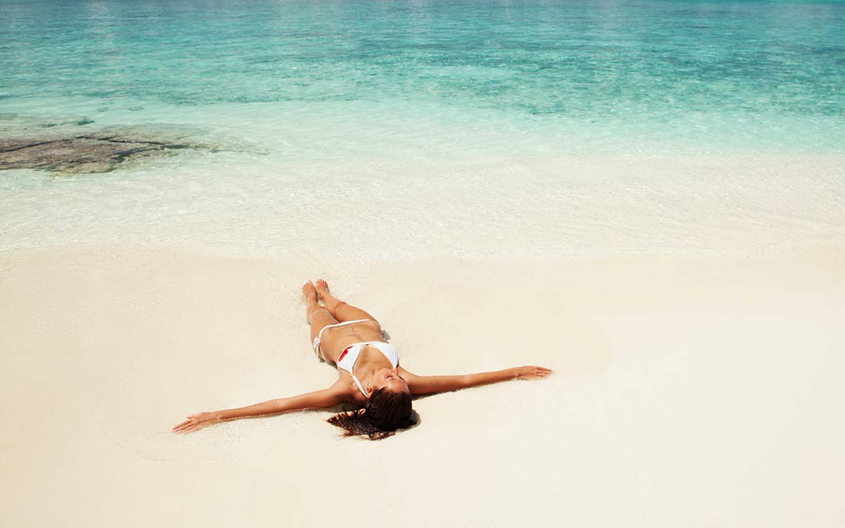 Woman Laying on Beach Woman Laying on Beach